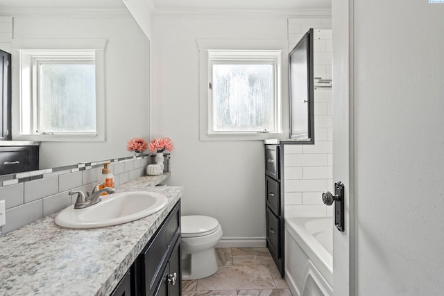 bathroom featuring crown molding, a tub, a wealth of natural light, and decorative backsplash