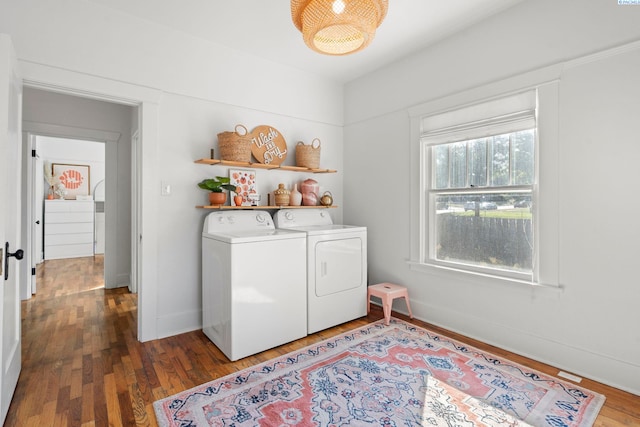 laundry room featuring separate washer and dryer and dark hardwood / wood-style flooring