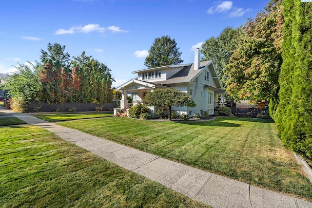 view of side of home with a yard