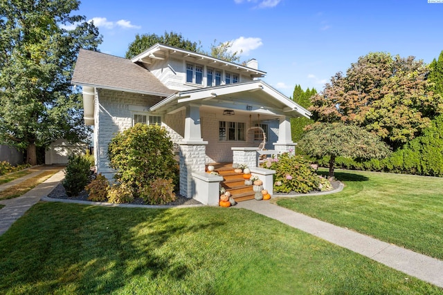 view of front facade with covered porch and a front lawn