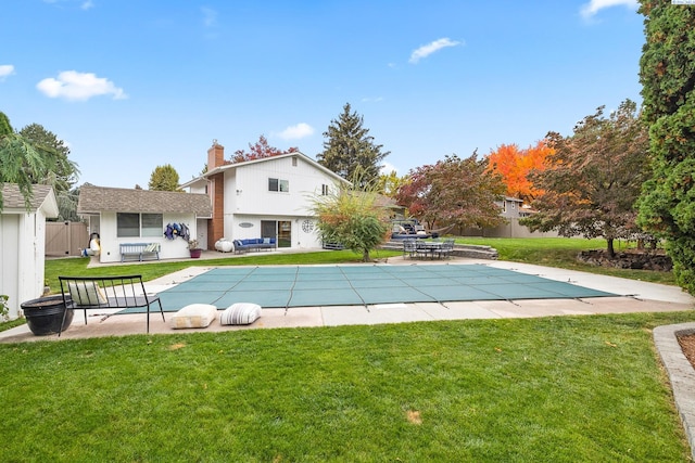 view of swimming pool with a patio and a lawn