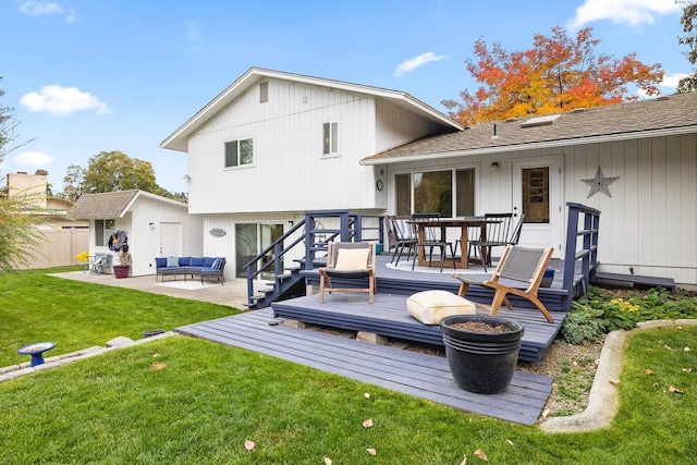 back of house featuring a wooden deck, a yard, outdoor lounge area, and a patio area