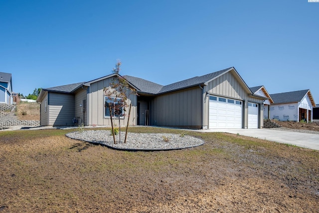 630 SW Cayuse St, Pullman, WA 99163 - view of front of house with a garage, board and batten siding, and driveway