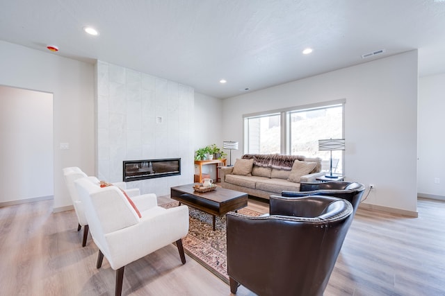630 SW Cayuse St, Pullman, WA 99163 - living room with light wood-style flooring, recessed lighting, and a tiled fireplace