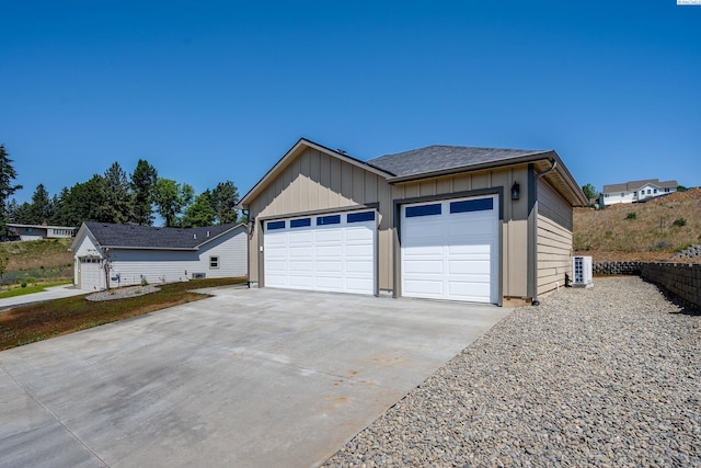 630 SW Cayuse St, Pullman, WA 99163 - view of front facade with board and batten siding, driveway, and an outbuilding