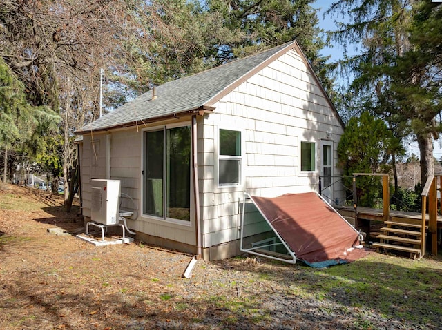 615 SW Winter Cir, Pullman, WA 99163 - view of property exterior with a shingled roof, a deck, and ac unit