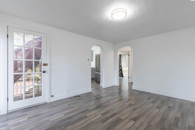 615 SW Winter Cir, Pullman, WA 99163 - empty room with arched walkways, wood finished floors, plenty of natural light, baseboards, and a textured ceiling