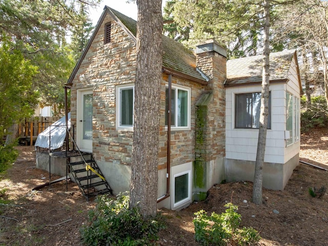 615 SW Winter Cir, Pullman, WA 99163 - view of side of home with stone siding and a chimney