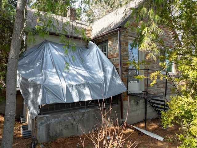 615 SW Winter Cir, Pullman, WA 99163 - view of home's exterior with a chimney and stone siding