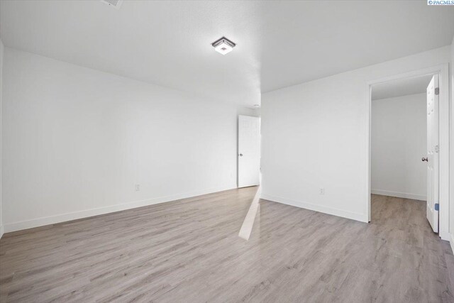 spare room with light wood-type flooring