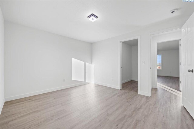 spare room featuring light hardwood / wood-style floors