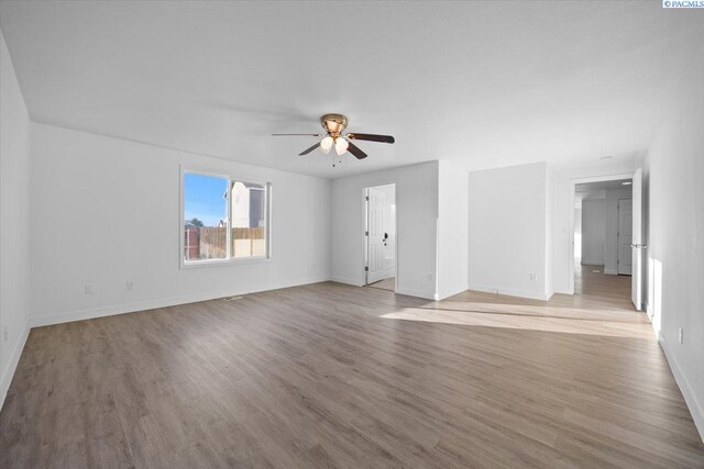 spare room featuring ceiling fan and light hardwood / wood-style floors