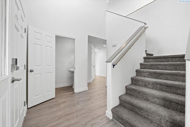 stairway with hardwood / wood-style flooring