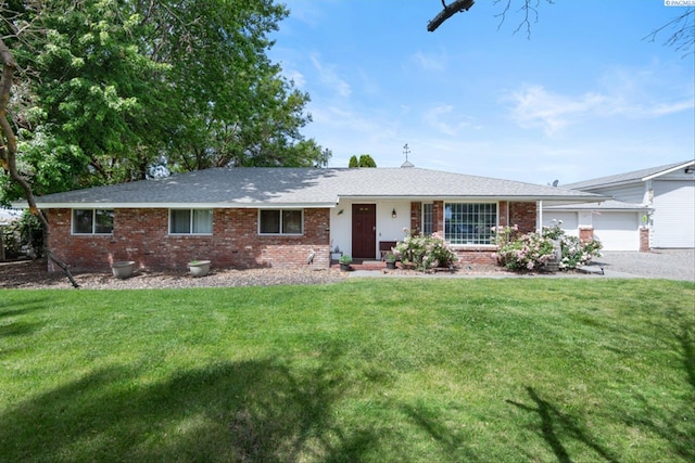 single story home featuring a garage and a front lawn