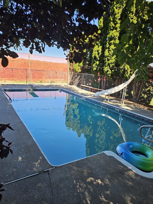 view of pool featuring a water slide