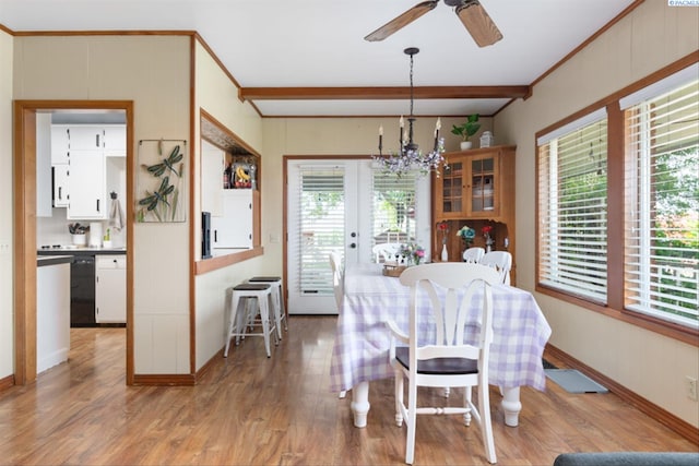 dining space featuring beam ceiling, ornamental molding, a wealth of natural light, and light hardwood / wood-style floors