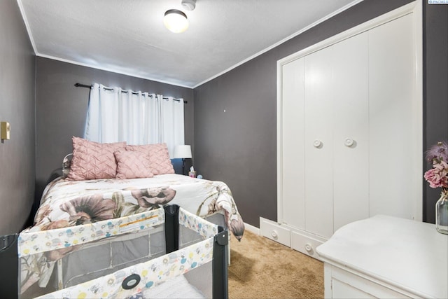 bedroom with crown molding, carpet floors, and a closet