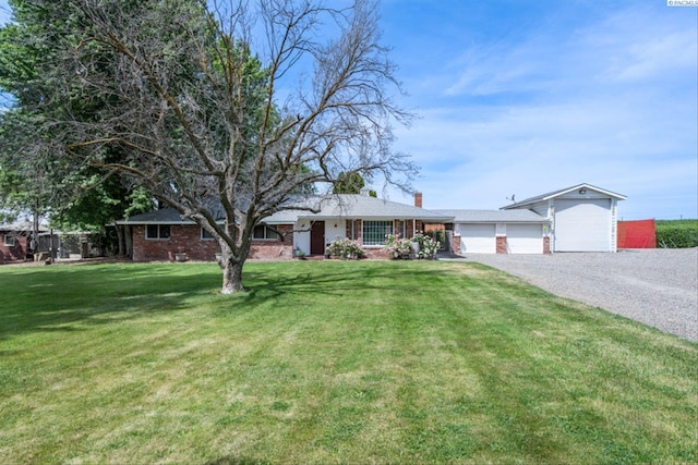 single story home featuring a garage and a front lawn