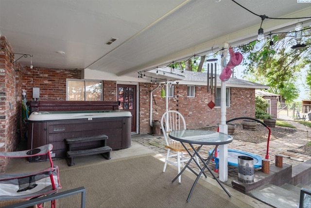 view of patio / terrace with a hot tub