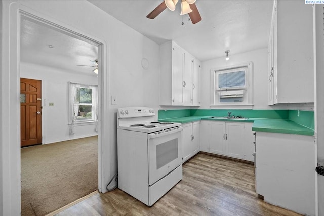 836 Main St, Prosser, WA 99350 - kitchen with electric stove, a ceiling fan, white cabinets, and light countertops