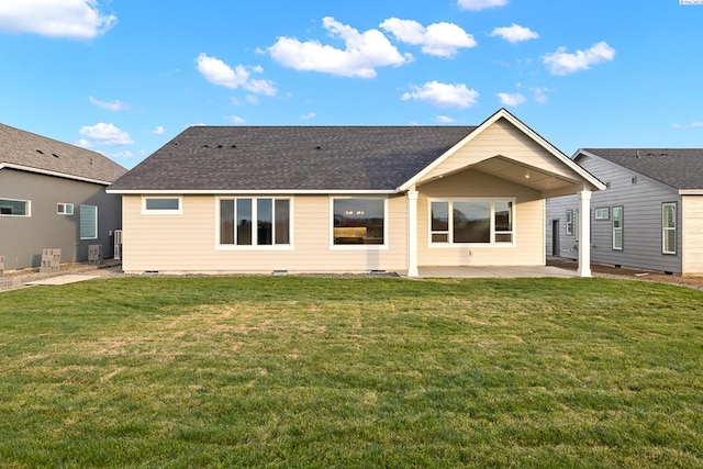 rear view of property featuring a lawn and a patio area