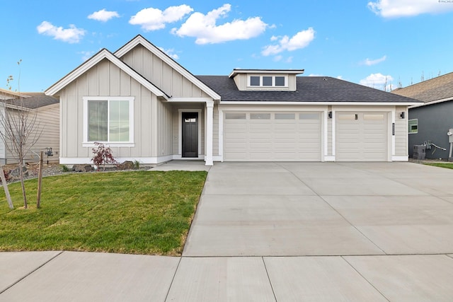 view of front of property featuring a garage and a front yard