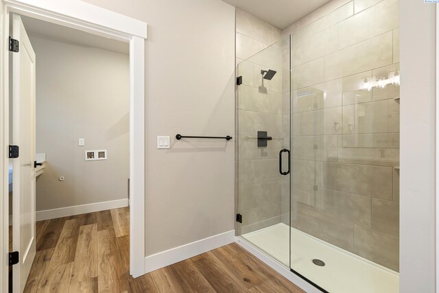 bathroom featuring a shower with door and hardwood / wood-style floors