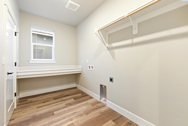 clothes washing area featuring hookup for a washing machine, light hardwood / wood-style flooring, and electric dryer hookup