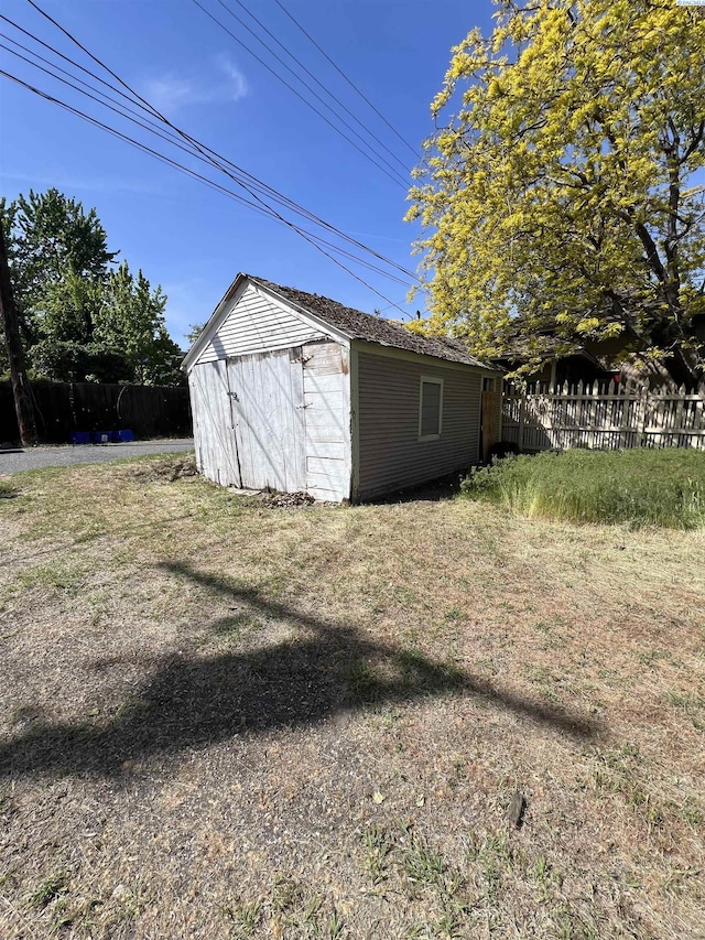 view of shed featuring fence