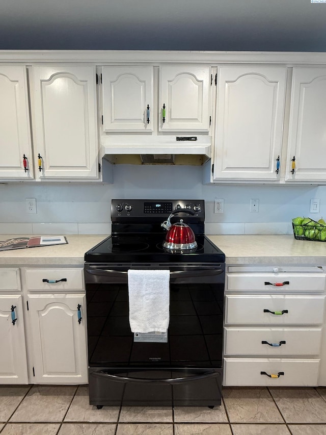 kitchen featuring light countertops, electric range, white cabinetry, and under cabinet range hood