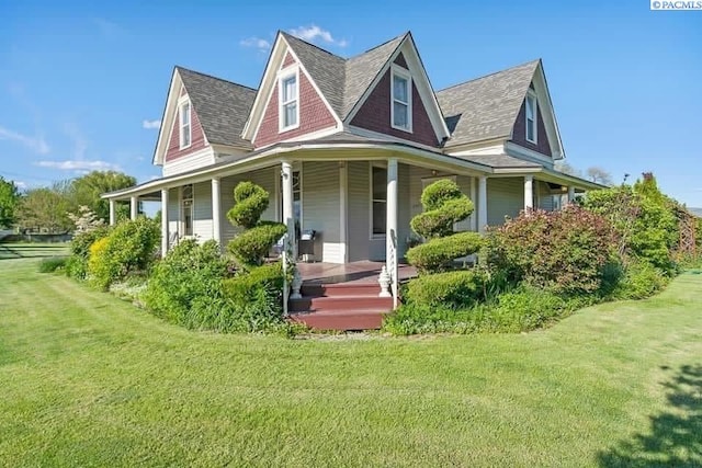 257 N Wamba Rd, Prosser, WA 99350 - farmhouse-style home featuring covered porch, a front yard, and a shingled roof