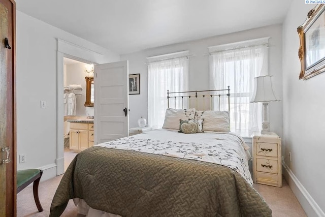 257 N Wamba Rd, Prosser, WA 99350 - bedroom featuring light colored carpet, baseboards, and ensuite bathroom
