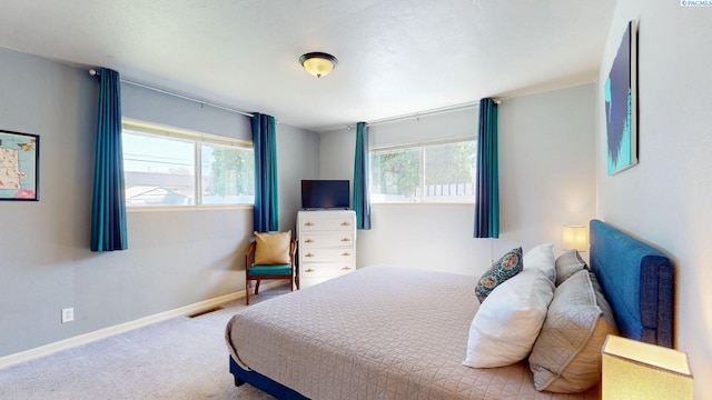 carpeted bedroom featuring baseboards and visible vents