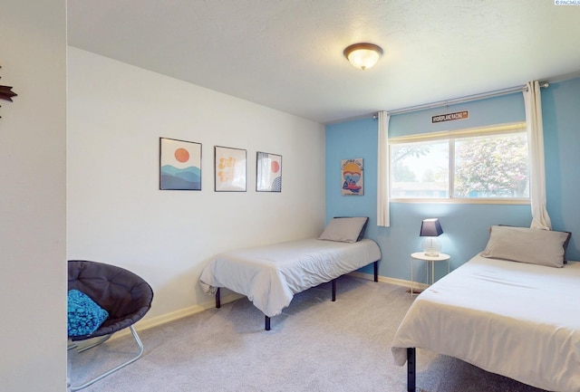 bedroom with baseboards and carpet