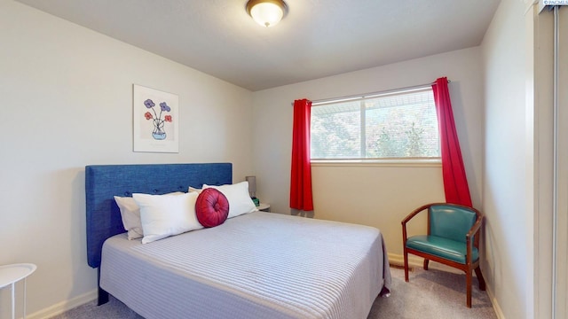 carpeted bedroom with baseboards