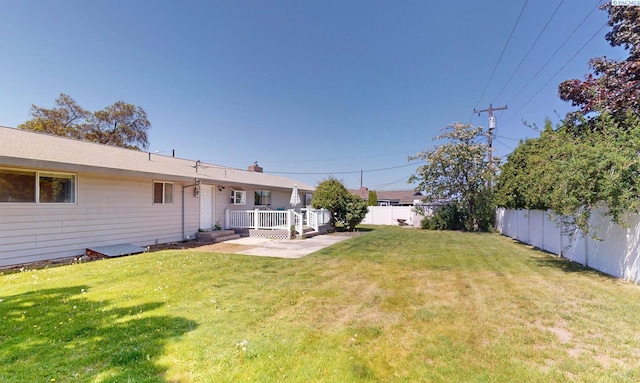 view of yard with a fenced backyard and a deck