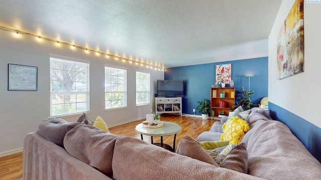 living area featuring light wood-style floors and baseboards