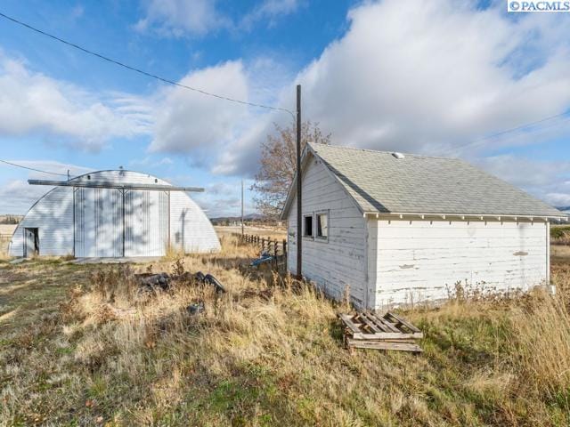 view of property exterior with an outdoor structure