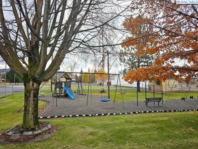 view of jungle gym with a lawn