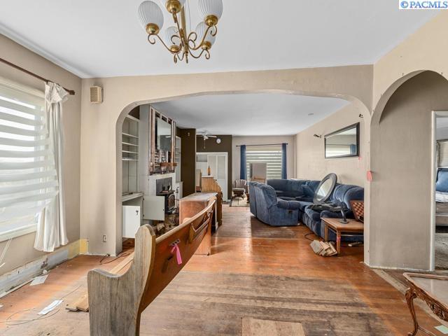 living room featuring a notable chandelier, hardwood / wood-style flooring, and plenty of natural light