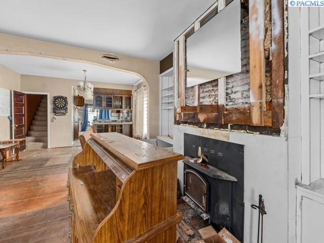 bar featuring hardwood / wood-style floors and a wood stove