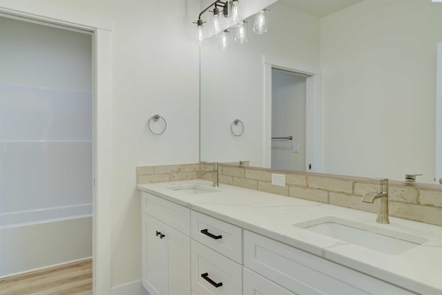 9418 Balflour Ct, Pasco, WA 99301 - bathroom with double vanity, a bath, and wood finished floors
