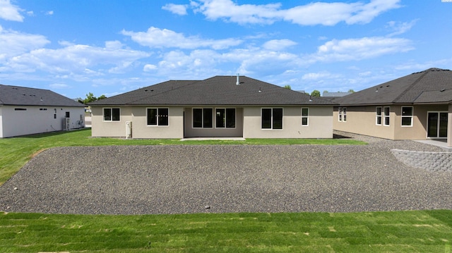 9418 Balflour Ct, Pasco, WA 99301 - back of property featuring stucco siding, a lawn, and a shingled roof