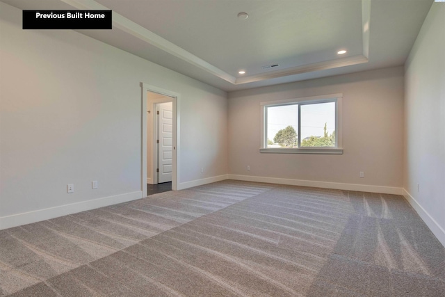 spare room featuring carpet, baseboards, a raised ceiling, and recessed lighting