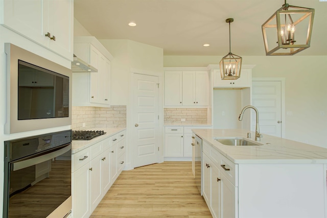 9418 Balflour Ct, Pasco, WA 99301 - kitchen featuring black oven, a sink, light wood-type flooring, tasteful backsplash, and recessed lighting