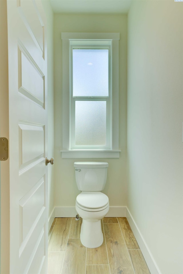 9418 Balflour Ct, Pasco, WA 99301 - bathroom featuring baseboards, toilet, and wood finished floors