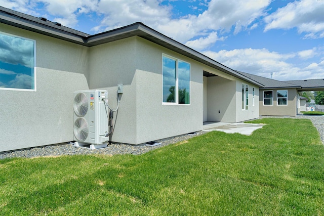 9418 Balflour Ct, Pasco, WA 99301 - rear view of property with a cooling unit, stucco siding, and a lawn