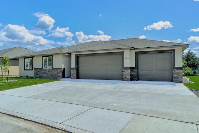 9418 Balflour Ct, Pasco, WA 99301 - prairie-style home with an attached garage, stone siding, concrete driveway, and stucco siding