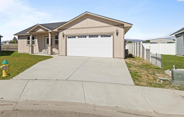 view of front of property with a garage and a front yard