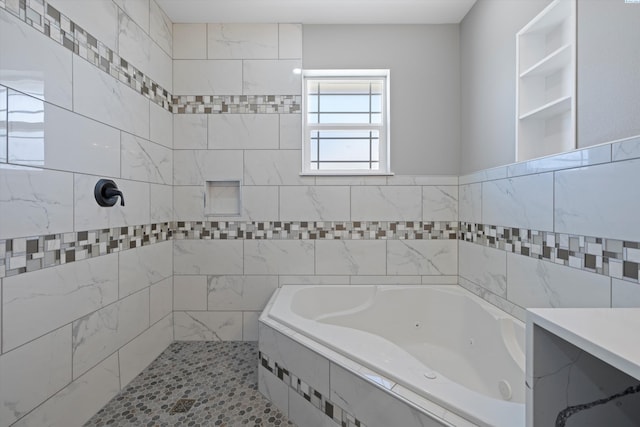 bathroom with a relaxing tiled tub